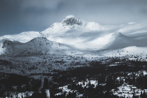 Free Mountain Coated With Snow Under Gray Sky Stock Photo