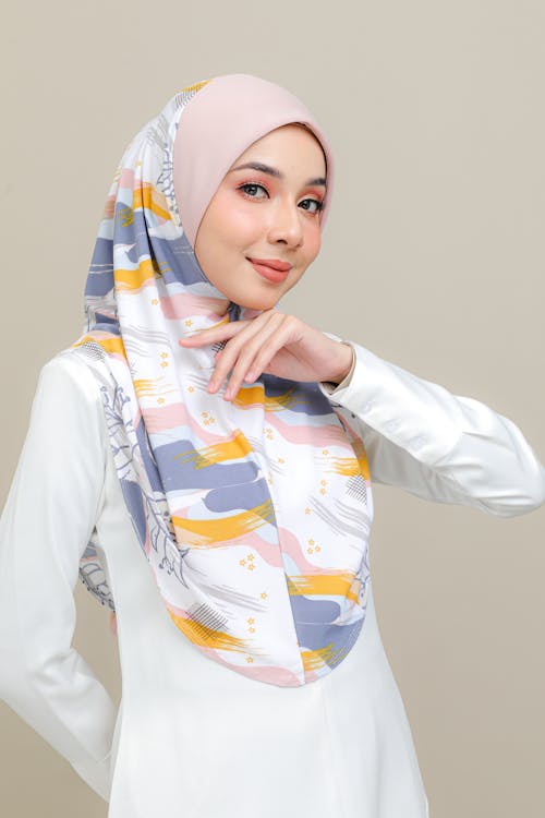 Woman in White Long Sleeve Shirt With Blue and White Hijab