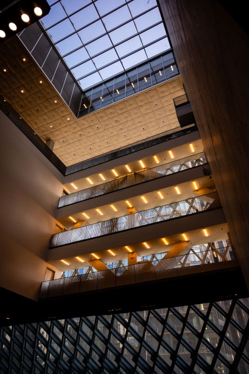 Free Futuristic interior of a modern building featuring a glass ceiling and distinctive lighting. Stock Photo