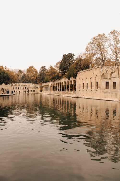Free Discover serene autumn reflections of historic architecture along a tranquil canal. Stock Photo