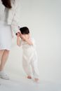 Man in White Dress Shirt and White Pants Kissing Woman in White Dress