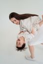 Woman in White Dress Shirt Carrying Baby in White Dress