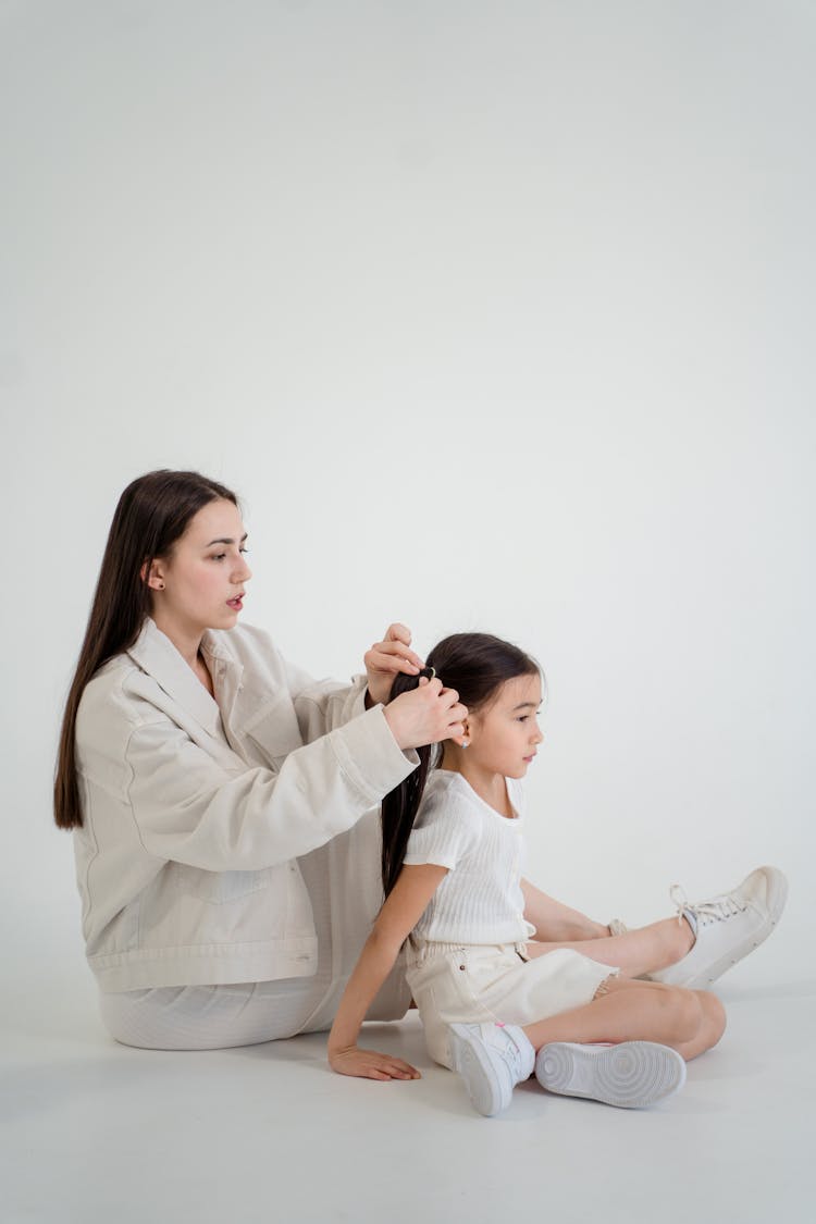 A Mother Fixing Her Daughter's Hair