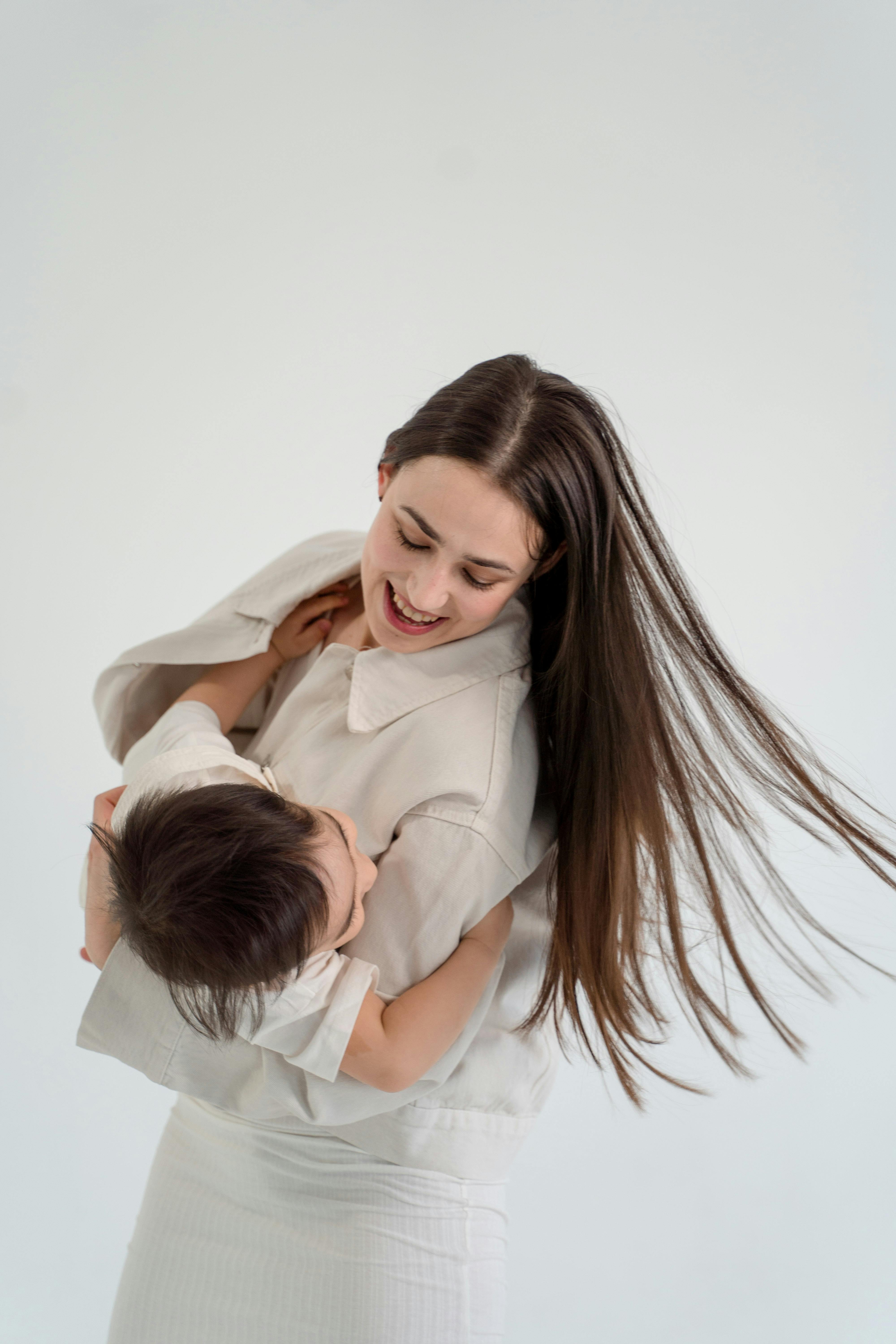 woman in white long sleeve shirt hugging man in white dress shirt