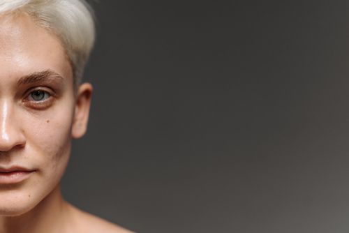 Free Close-up headshot of a Caucasian woman with gray hair against a neutral background. Stock Photo