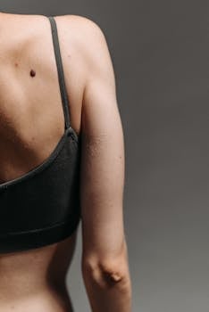 An artistic close-up of a person's back and shoulder with a focus on the skin texture. Ideal for healthcare themes.