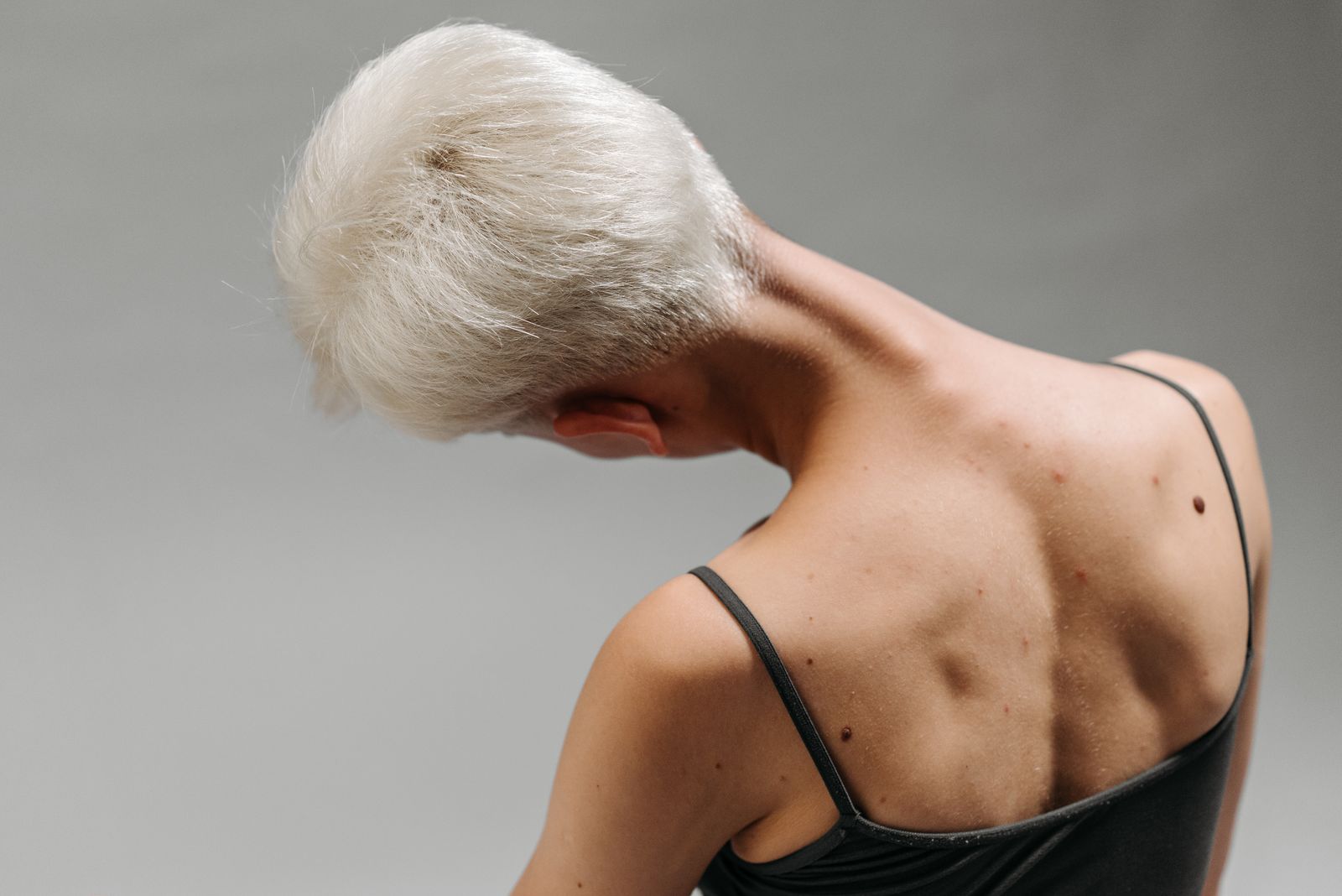 Person stretching upper and lower back in a bright physiotherapy studio