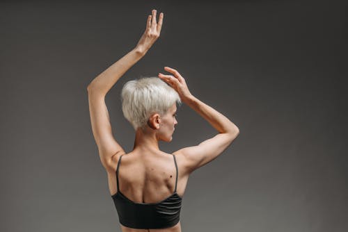 A Woman Raising Her Arms and Posing