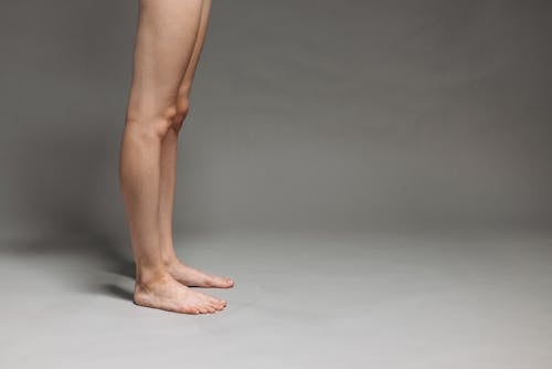 Free Womans Legs on White Surface Stock Photo