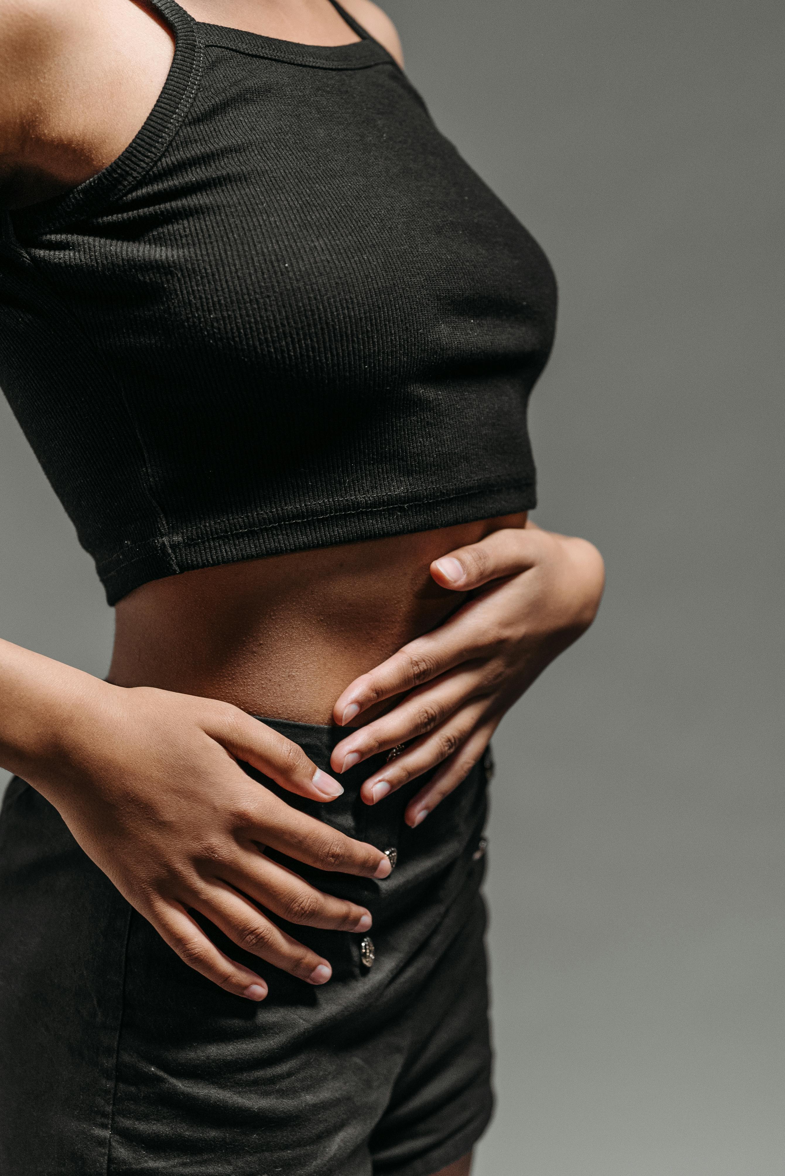 Medical professional examining patient with abdominal conditions