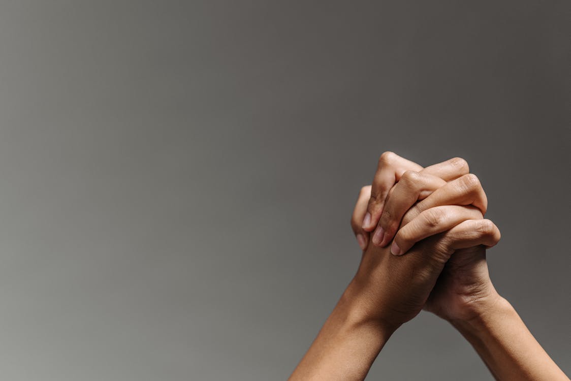 Persons Hand on Gray Background