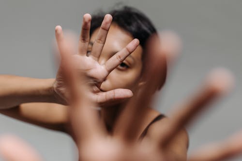 A Woman Covering Face with Her Hands