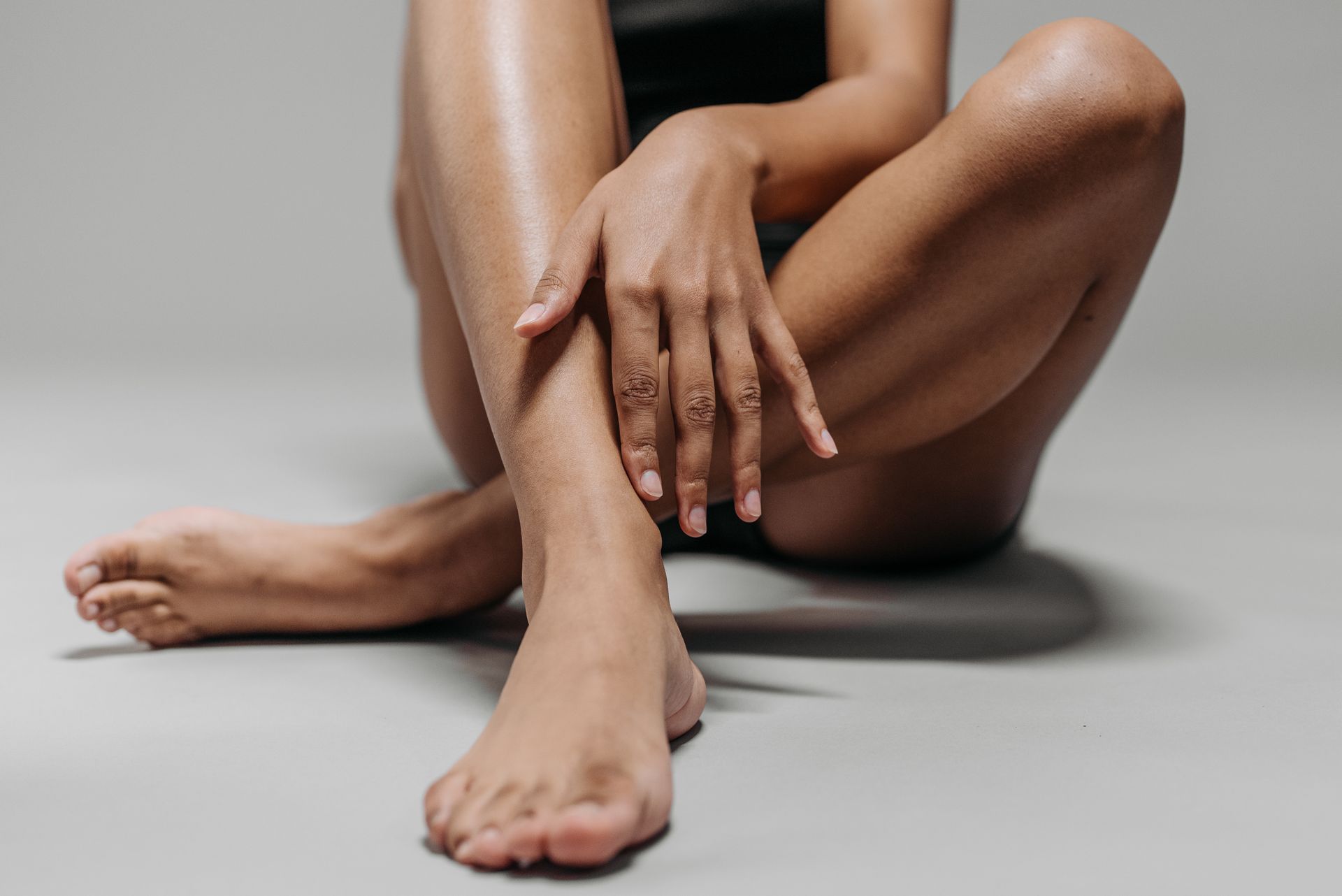 Woman Sitting on the Floor with Her Legs Crossed