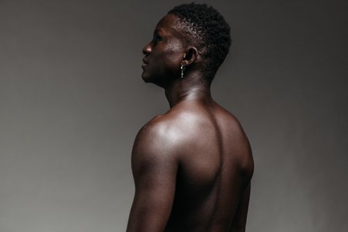 Free Portrait of a shirtless African American man looking afar. Strong masculinity theme. Stock Photo