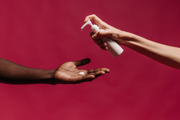 Photo Of Hand Giving Lotion On Hand