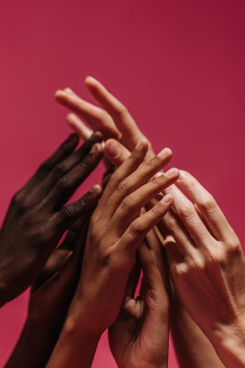 Hands Touching Against Red Background