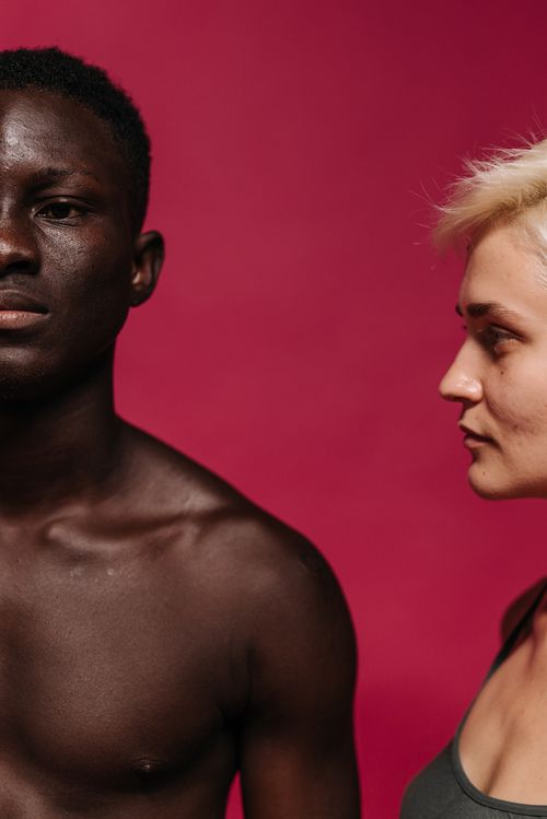 Free Close-up portrait of interracial couple against pink background. Stock Photo
