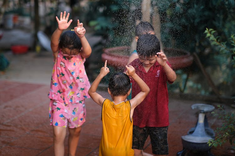 Selective Focus Photo Of Children Playing In The Rain