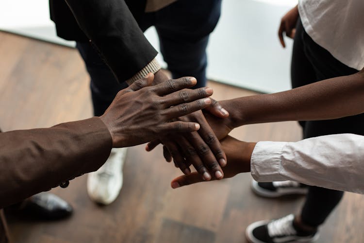 Close-up Photo Of Team Huddle