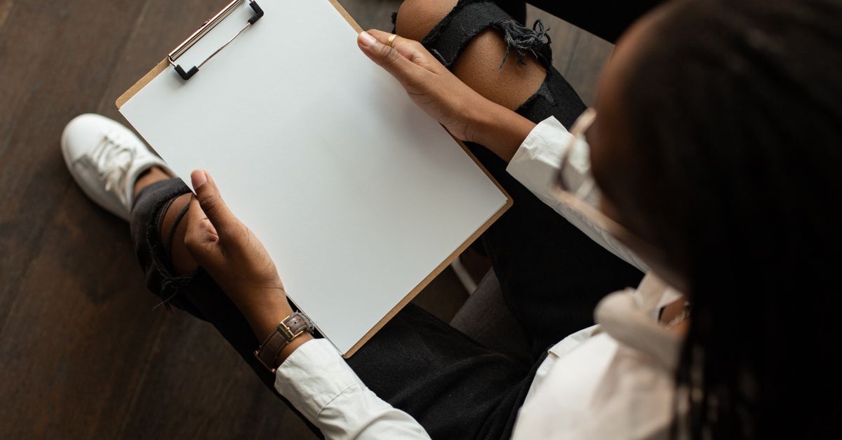 Top view of a person with a blank clipboard, ideal for mockup designs.