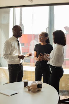 Professionals discussing a project in a modern office setting.