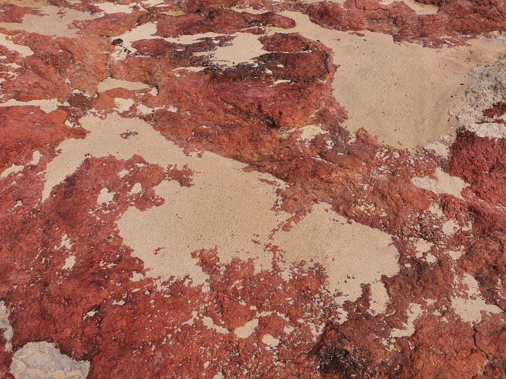 Red Rock Surface with Brown Sand · Free Stock Photo