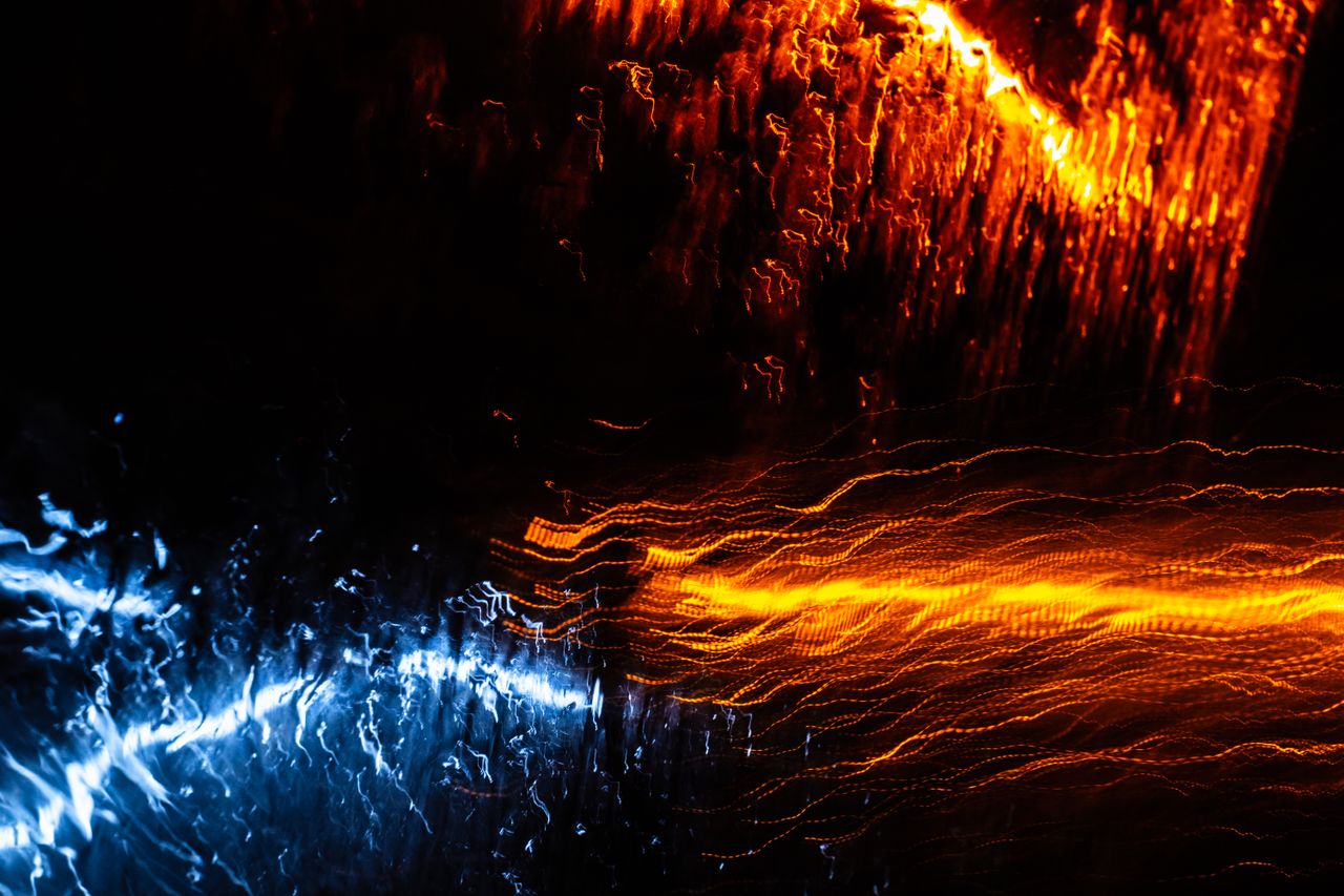 dynamic abstract light streaks in blue and orange creating an energeti