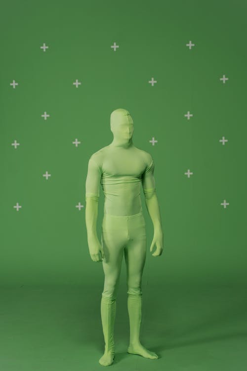Person in Green Suit Standing in Studio