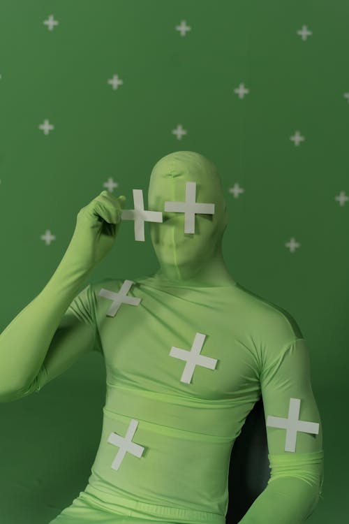 A Person in Green Bodysuit with White Cross