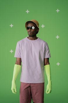 Trendy man with pixelated sunglasses and neon gloves posing in a modern fashion setting. — photo by cottonbro studio