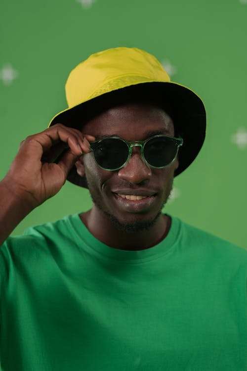 Free Man in Green Shirt Wearing Yellow Hat and Green Framed Sunglasses Stock Photo
