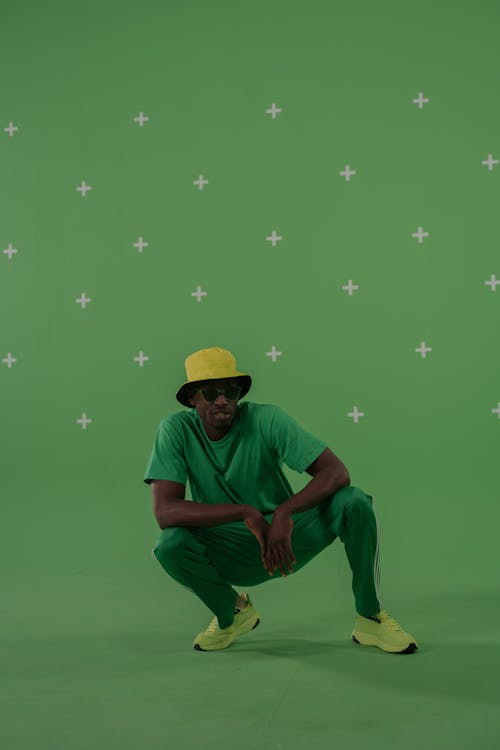 A Man in Green Clothes Posing on the Camera