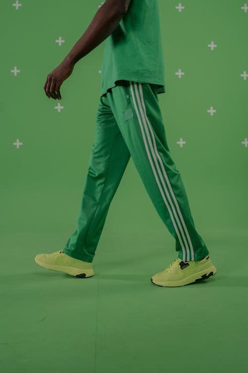 Person in Green Pants and Yellow Green Sneakers