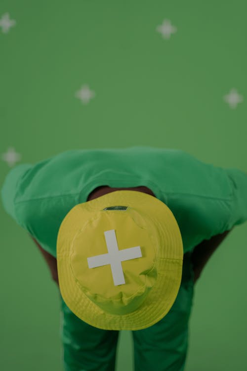 A Person in Green Shirt Wearing Yellow Bucket Hat