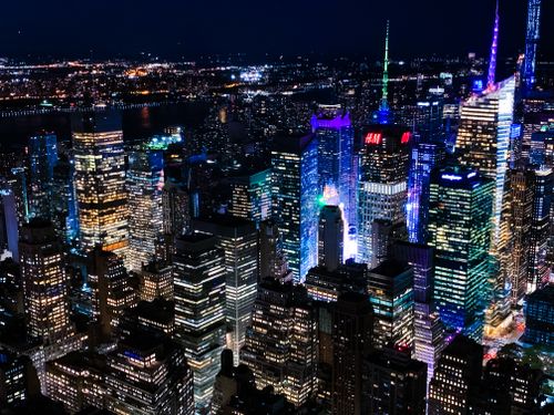 Free Vibrant aerial view of New York City's skyline at night, showcasing illuminated skyscrapers. Stock Photo