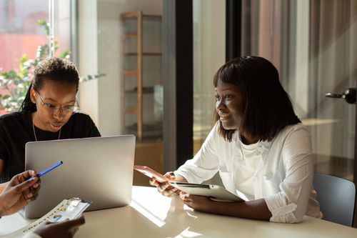 Free Business meeting with diverse adults collaborating in a modern office setting. Stock Photo
