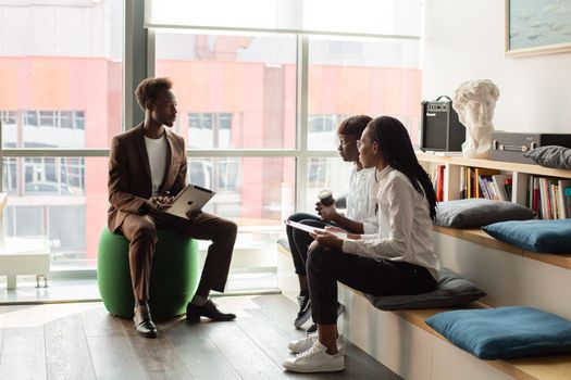 Business professionals having a meeting in a modern office setting, fostering teamwork and innovation.