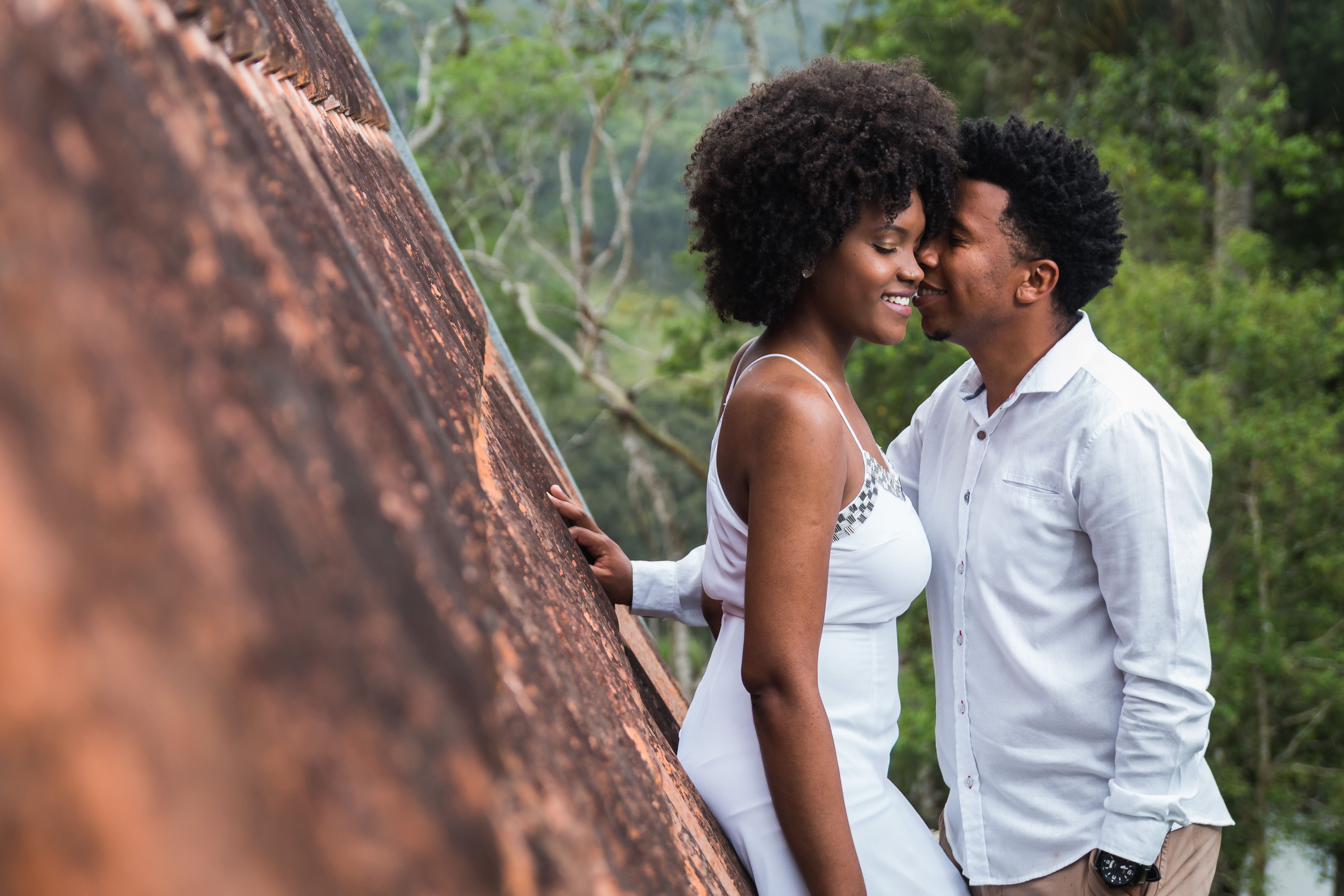 A loving couple shares an intimate moment in a natural setting, highlighting romance and connection.