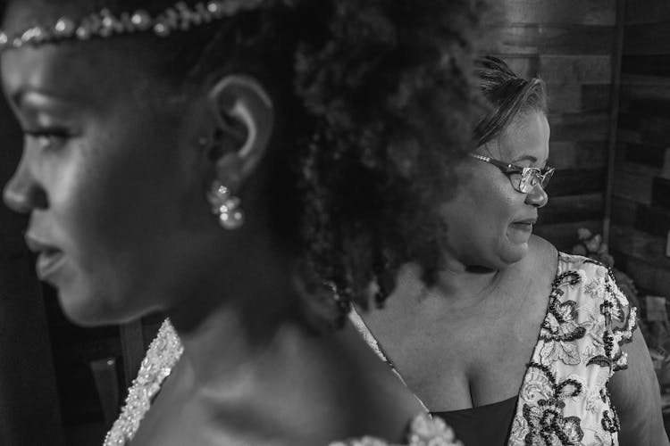 Mother And Daughter Preparing For Wedding Ceremony