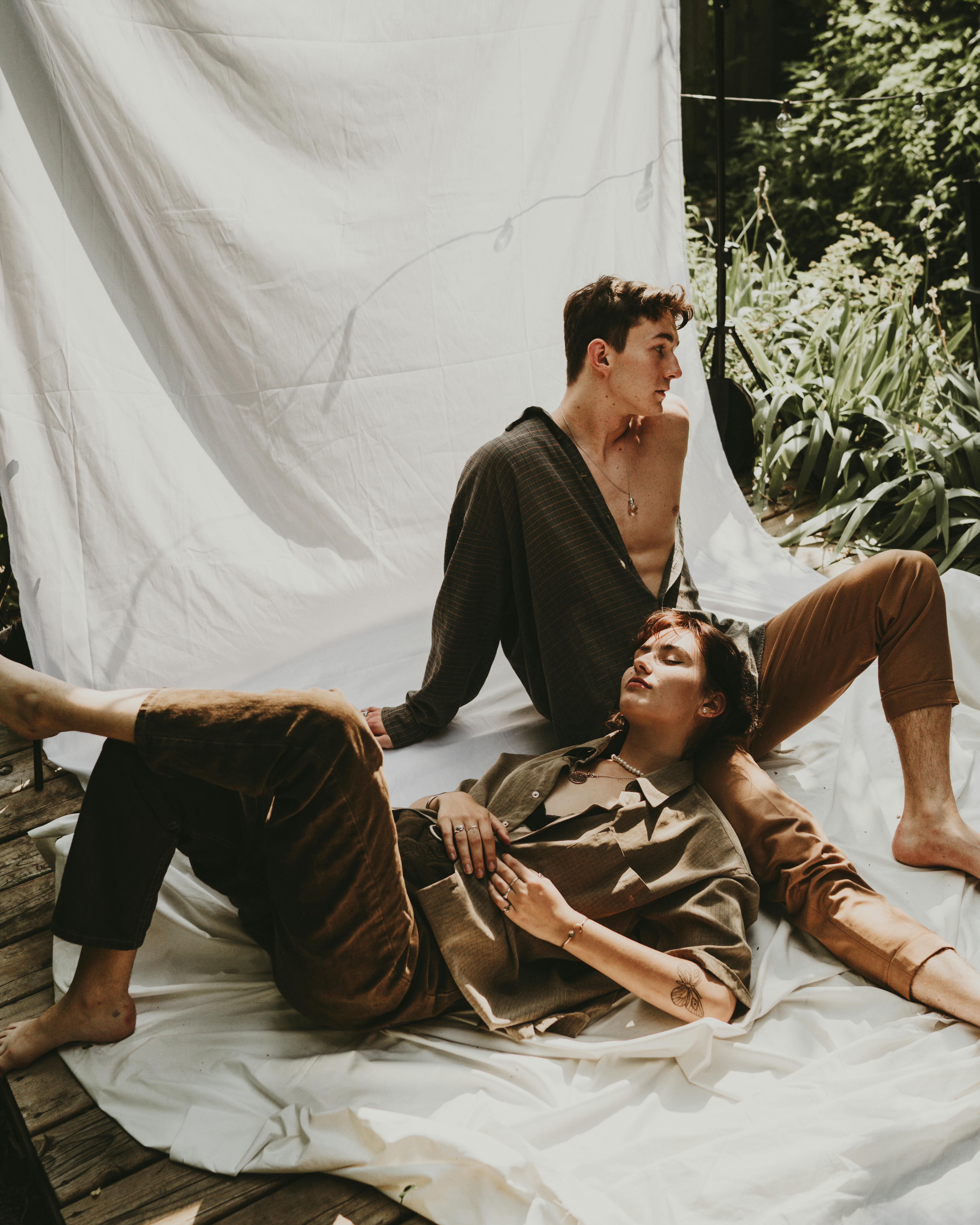 a man and a woman posing together on a white backdrop