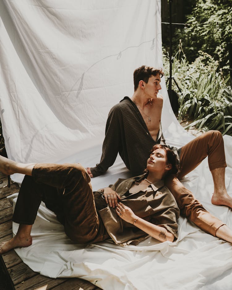 A Man And A Woman Posing Together On A White Backdrop