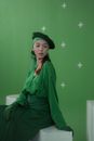 Woman in Green Robe Wearing Black Hat