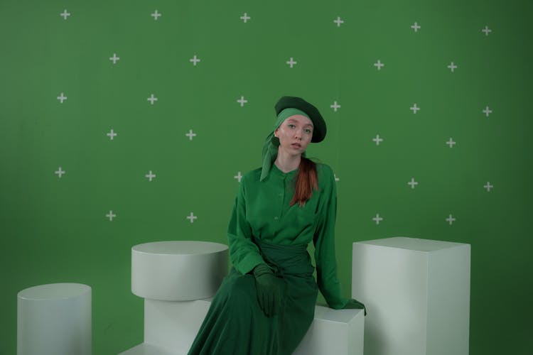 
A Woman In A Green Outfit Sitting