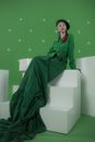 Woman in Green Robe Sitting on White Chair