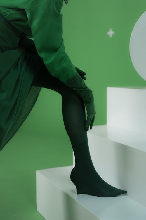Person in Green Dress and Black Stockings