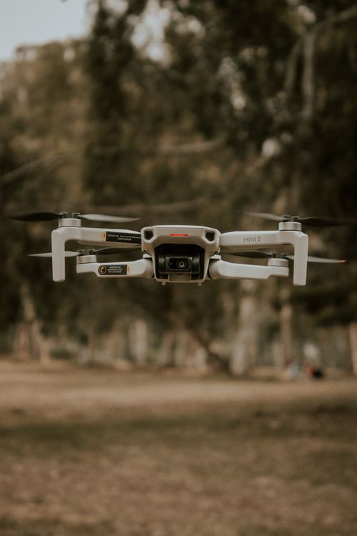 Free Close-up of a drone hovering outdoors in a forest setting. Stock Photo