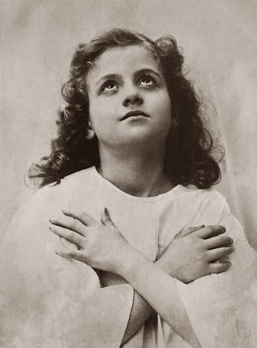 Old Photo of Girl with Arms Crossed and Looking Up