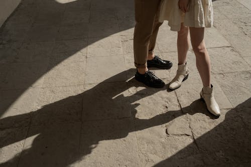 Free Two Persons in Leather Shoes Standing on Gray Concrete Floor Stock Photo