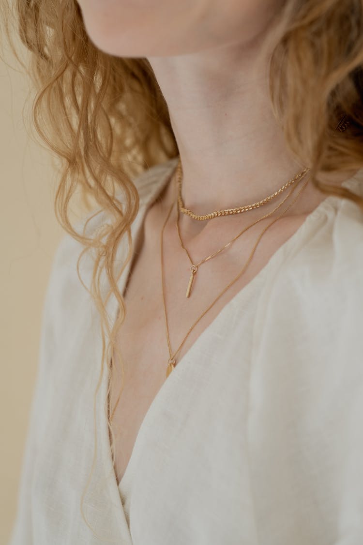 A Woman With Gold Necklaces