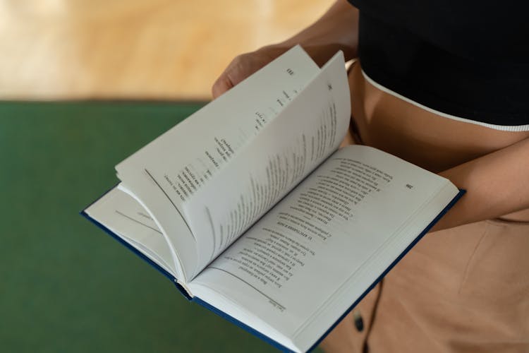 Hand Of A Person Scanning A Book